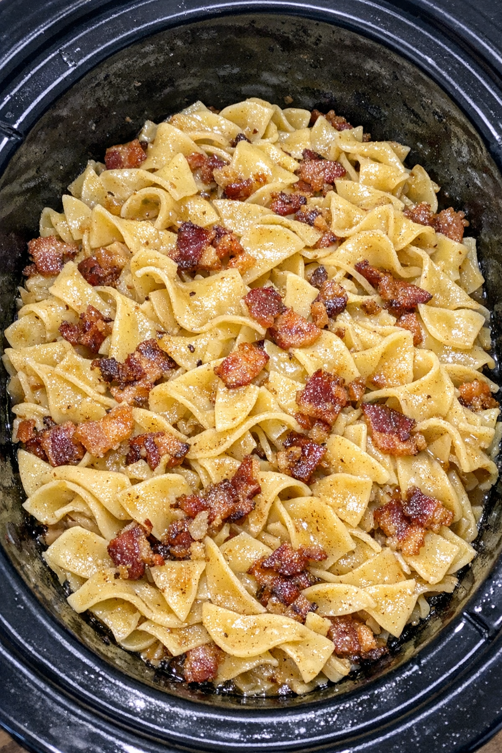 Slow cooker Amish bacon fat noodles in a black slow cooker