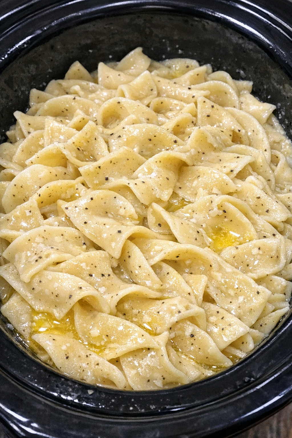 Slow cooker Amish white pepper noodles in a black slow cooker