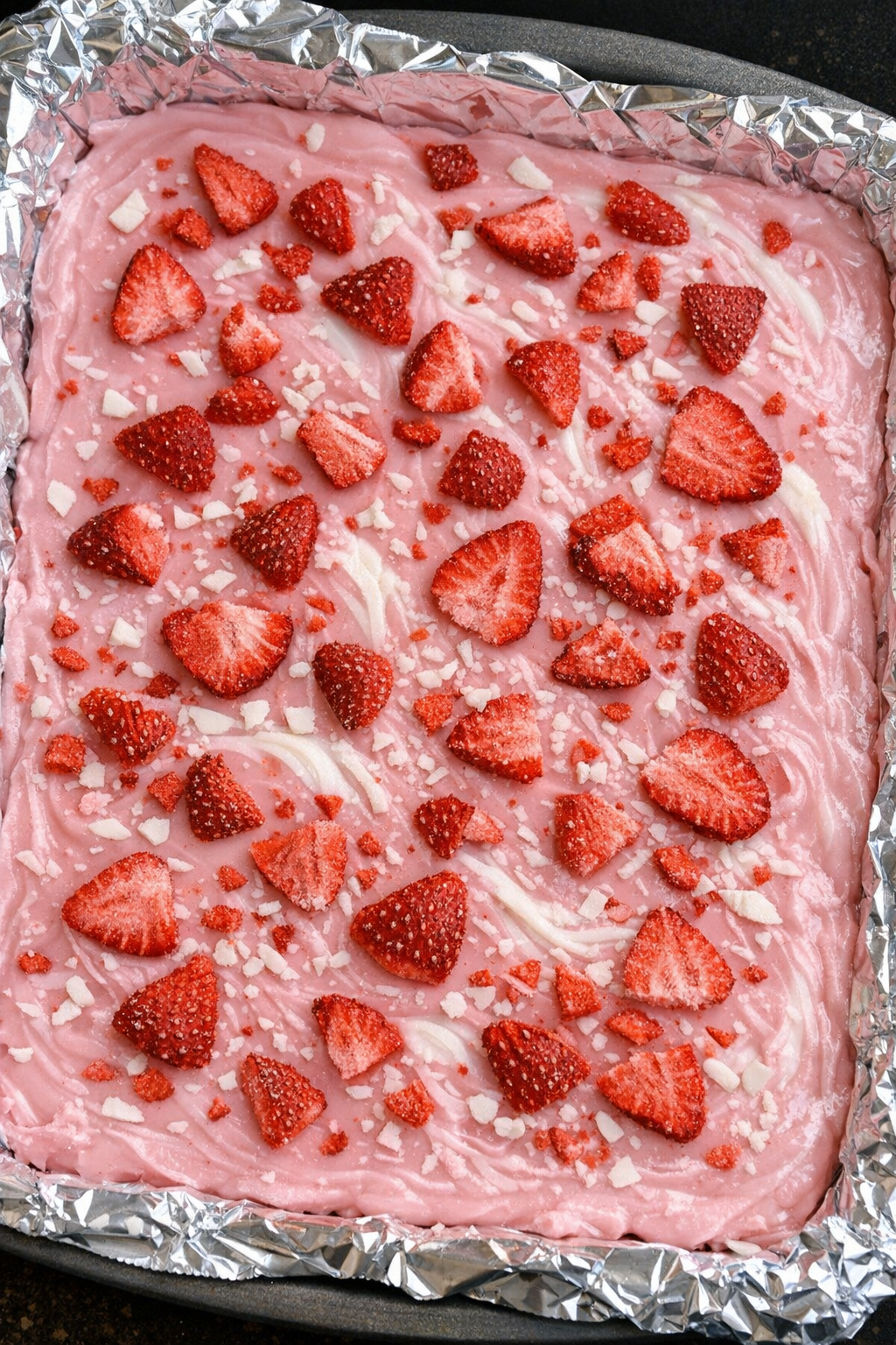 Slow cooker 3-ingredient pink refresher fudge in a foil-lined baking sheet