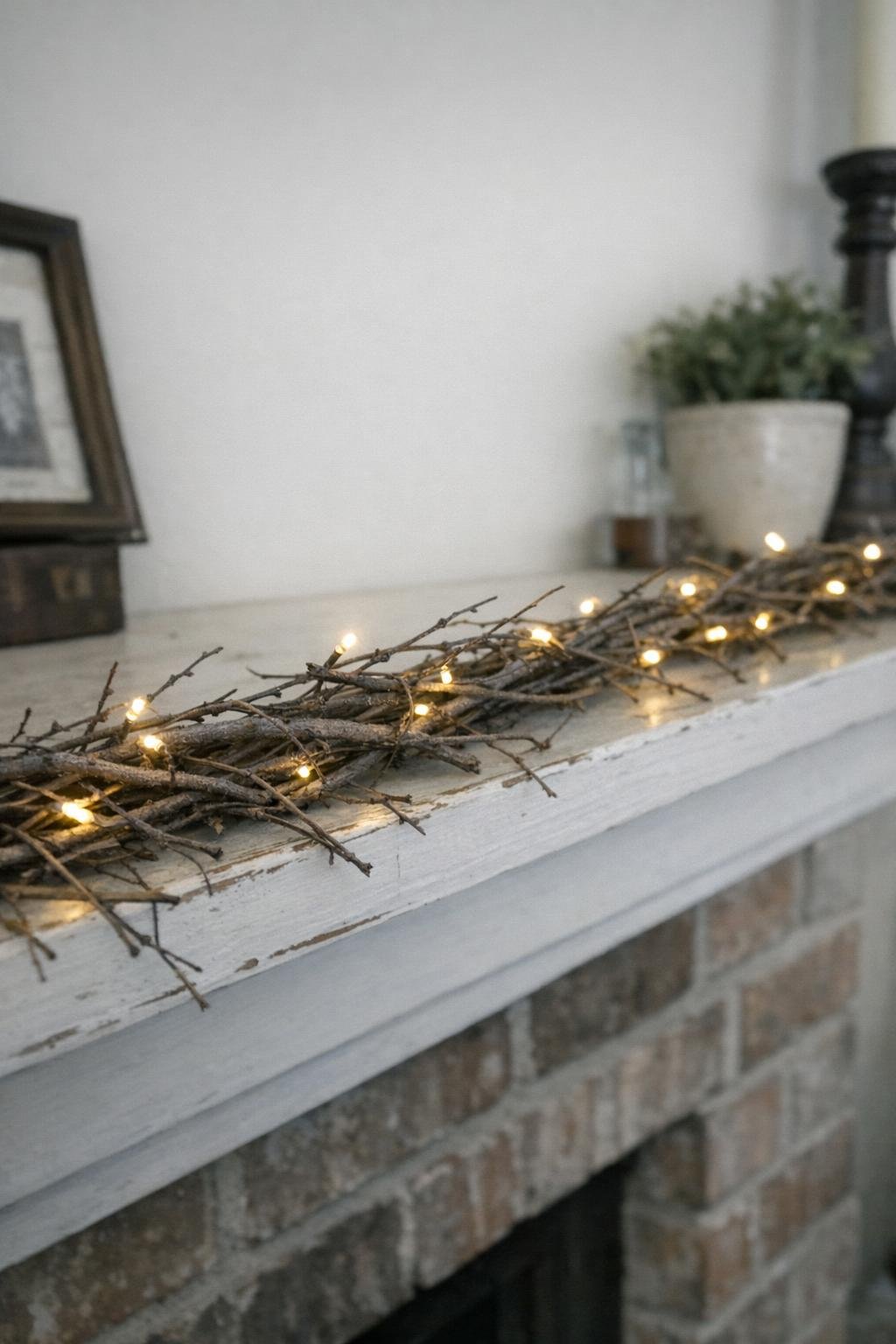 Branch garland with fairy lights on a mantel