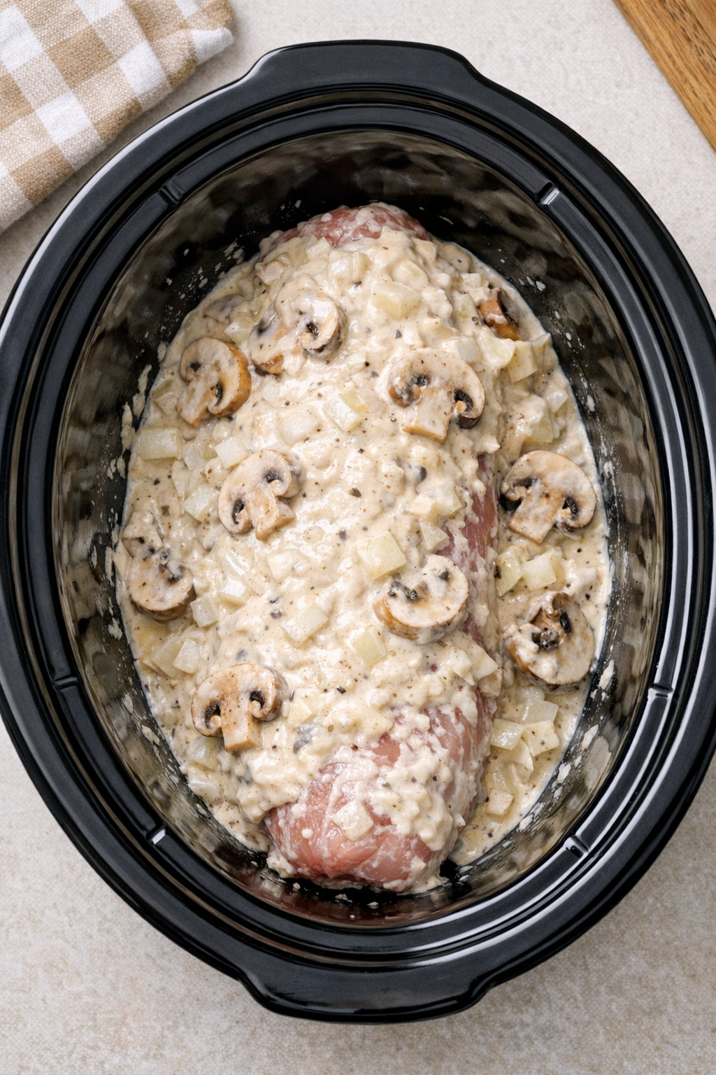 Pork tenderloin coated with creamy onion sauce in the slow cooker