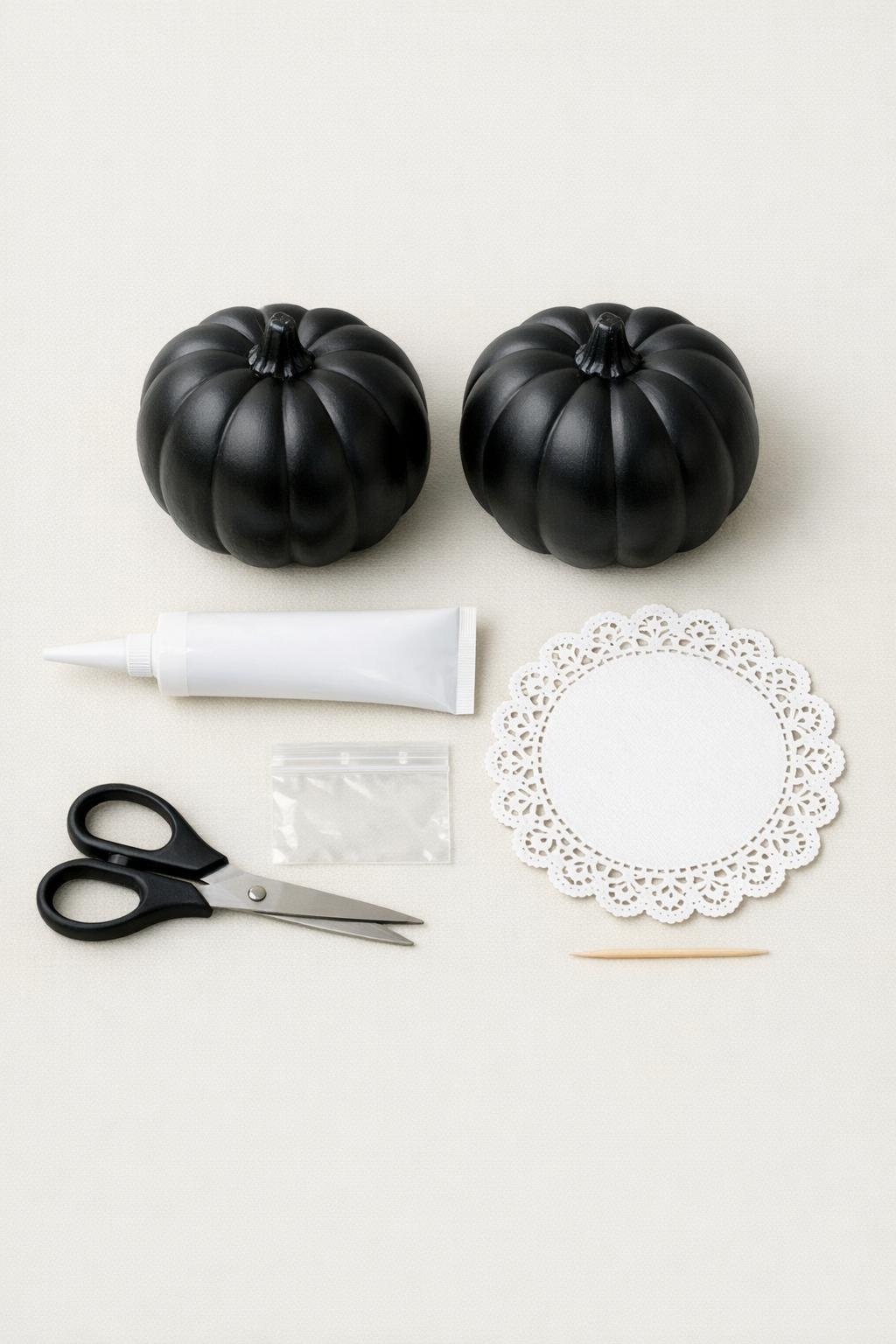 Materials for making black lace pumpkins laid out on a table