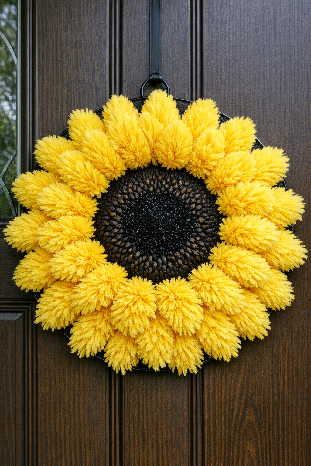 Finished giant sunflower front door wreath made from yellow dusters and a black splatter screen