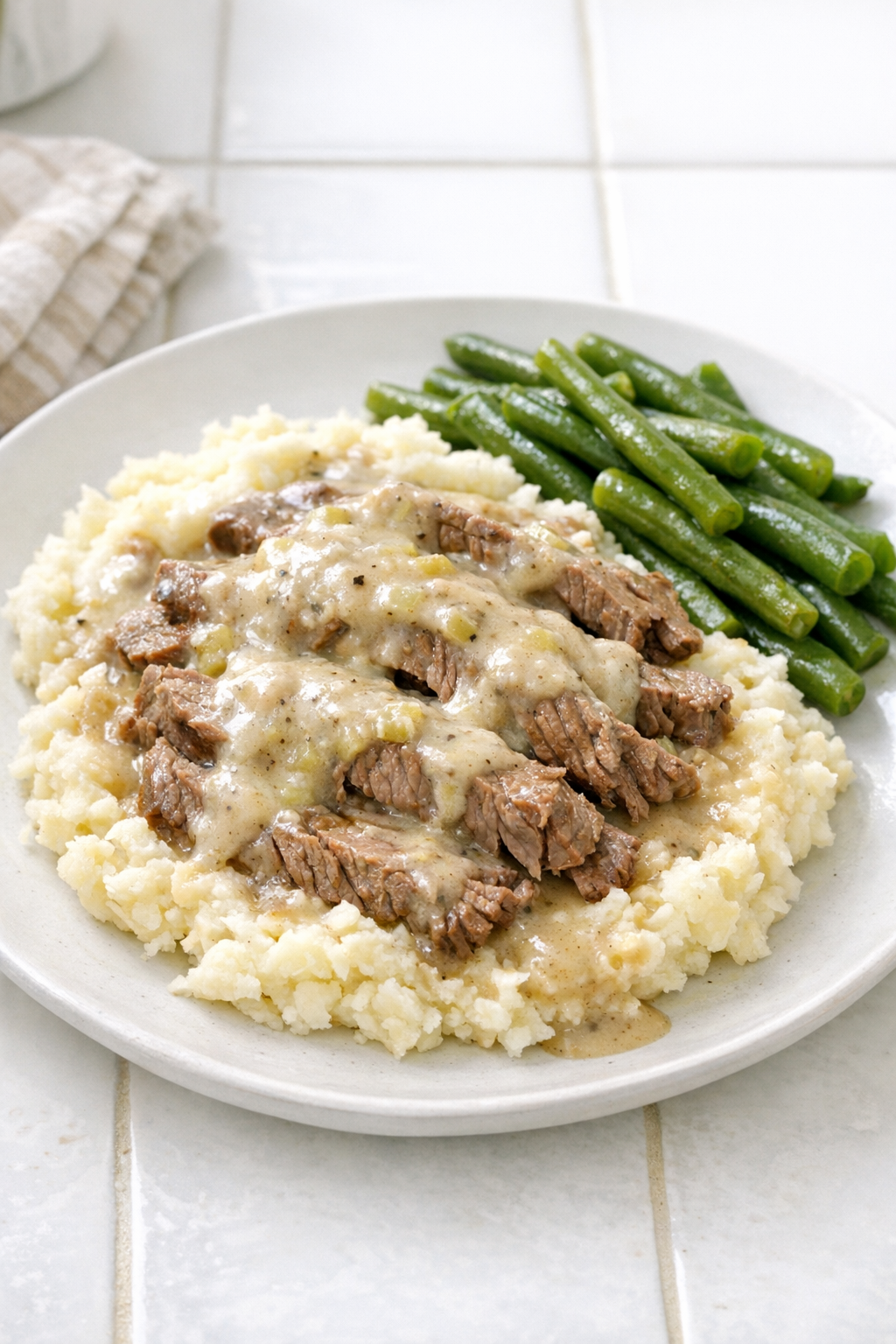 Finished slow cooker cream of celery beef plated with creamy gravy