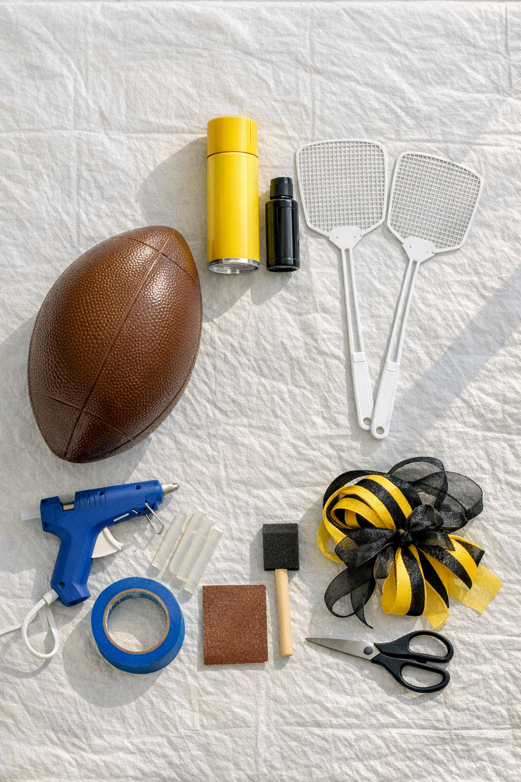 Materials for making a giant bumblebee front door hanger laid out on a table