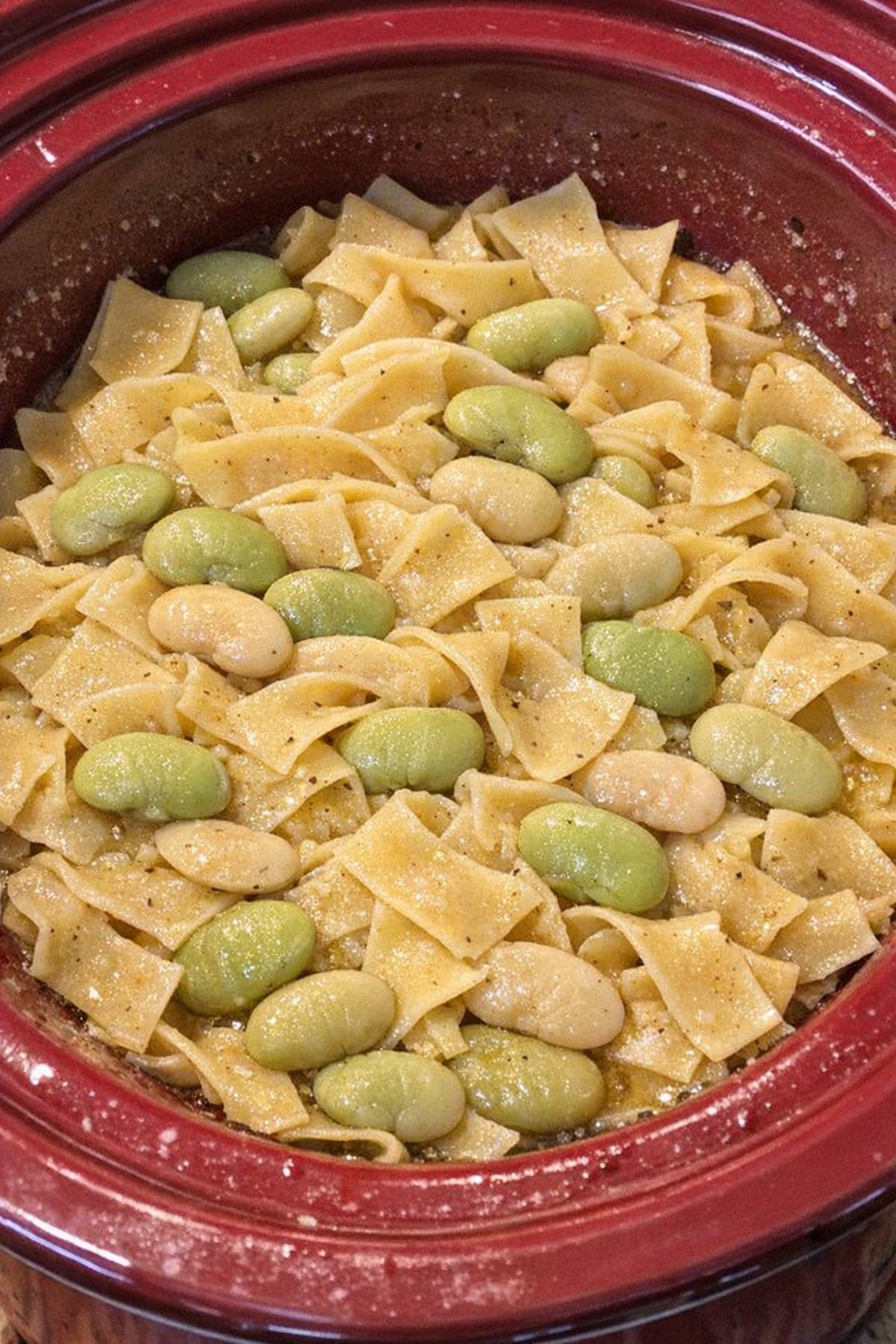 Slow cooker Amish lima bean noodles in a red slow cooker