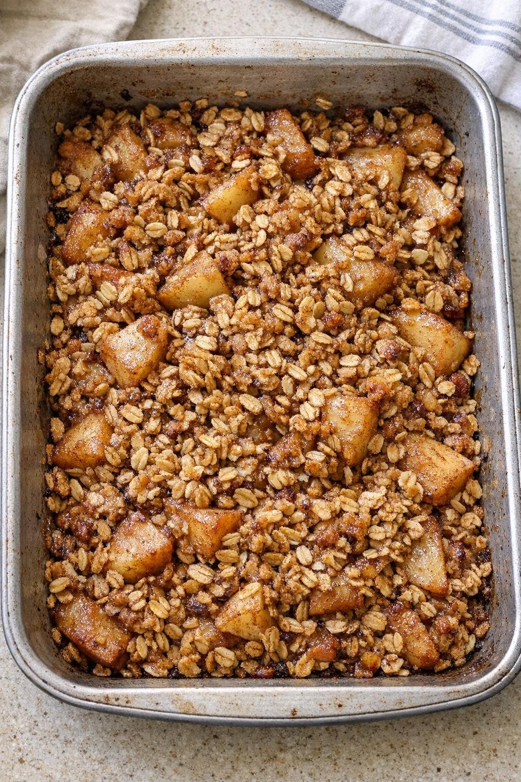 Warm baked apple oat dessert in a roasting pan