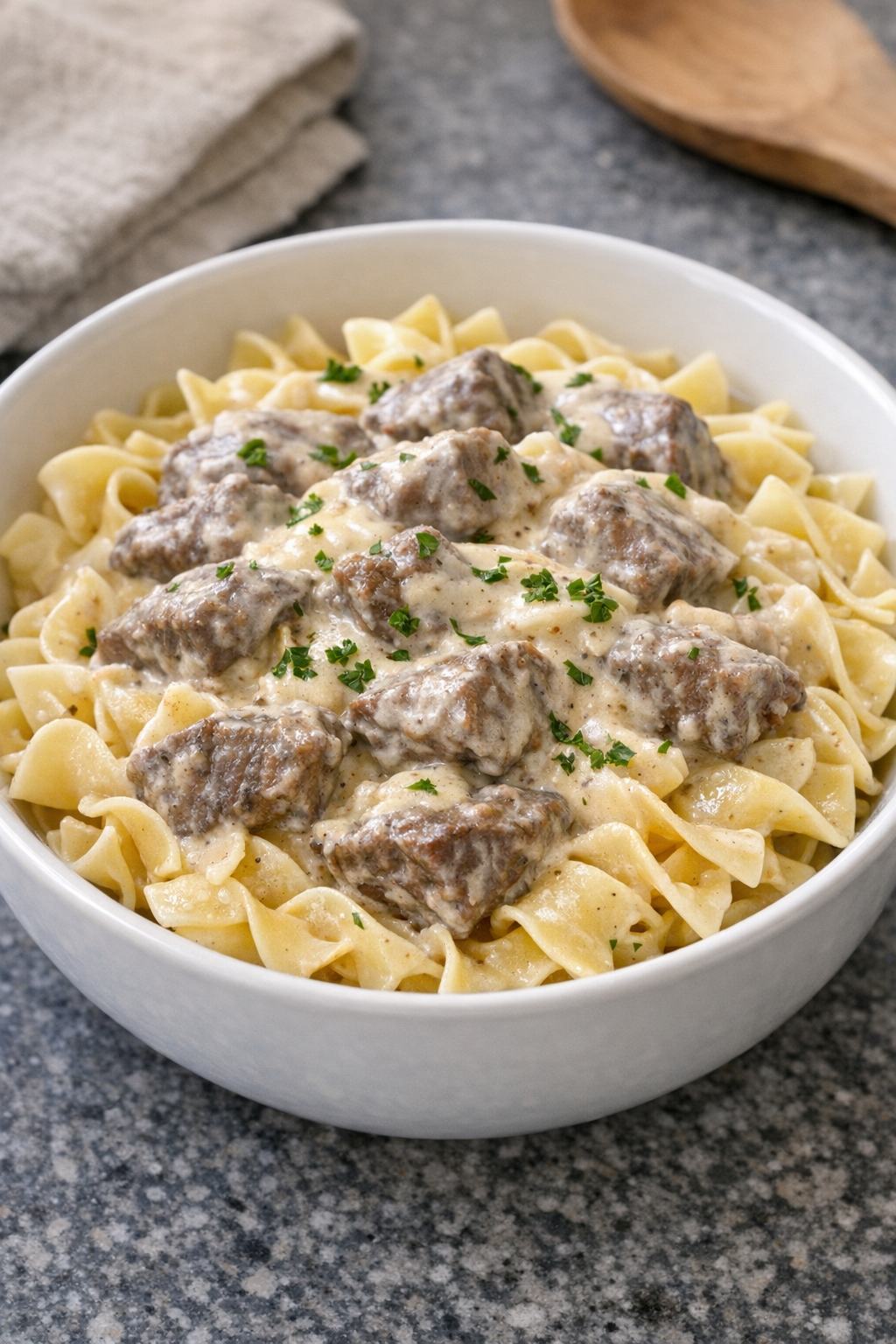 Finished creamy beef pasta plated in a bowl