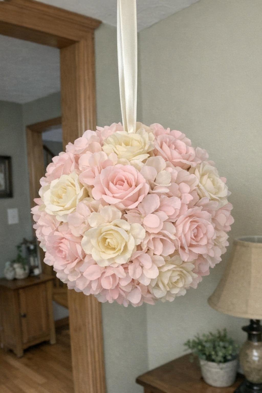 Silk-flower kissing ball hanging indoors