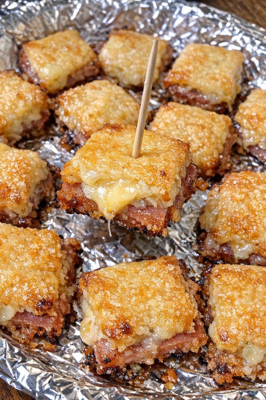 3-ingredient ham beauregard bites on a foil-lined platter