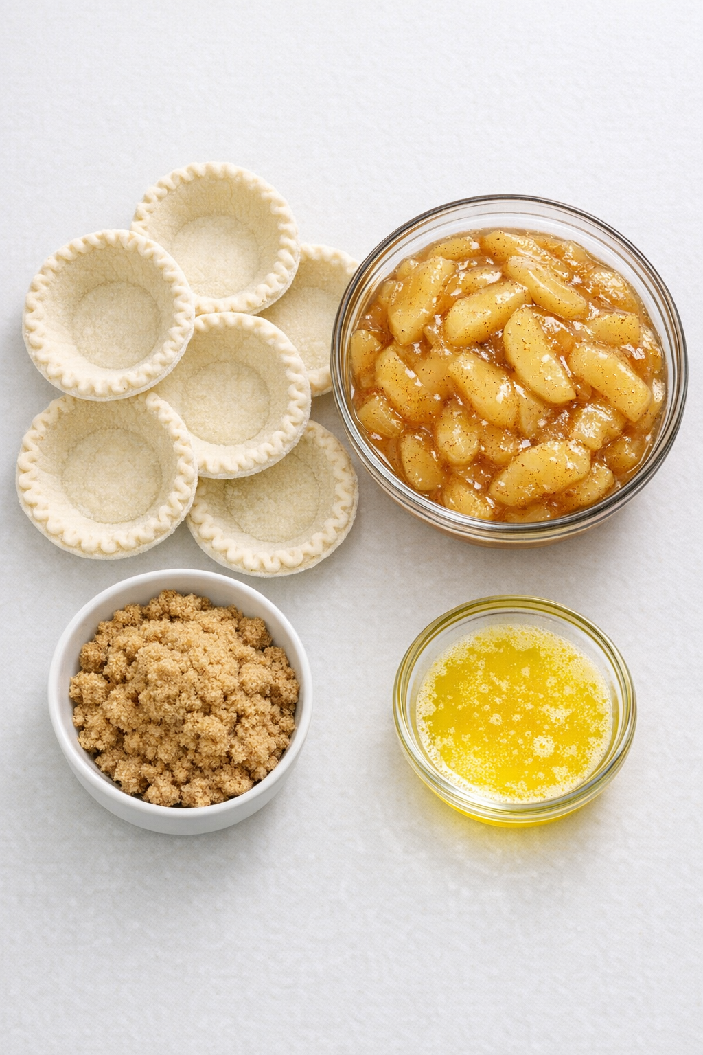 Mini pie crusts, apple pie filling, brown sugar, and melted butter