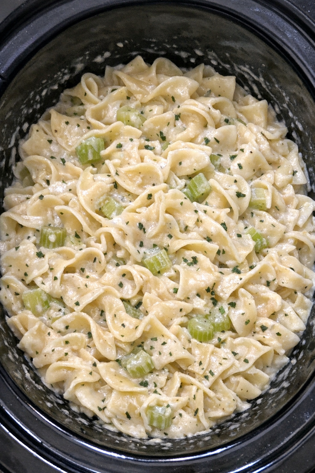 Creamy celery noodles in a black slow cooker