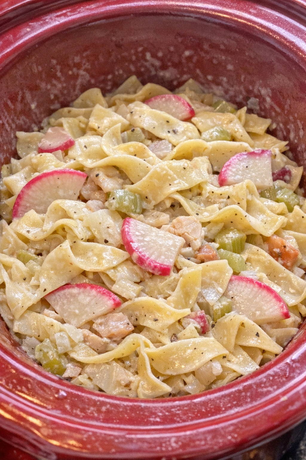 Slow cooker Amish radish noodles in a red slow cooker