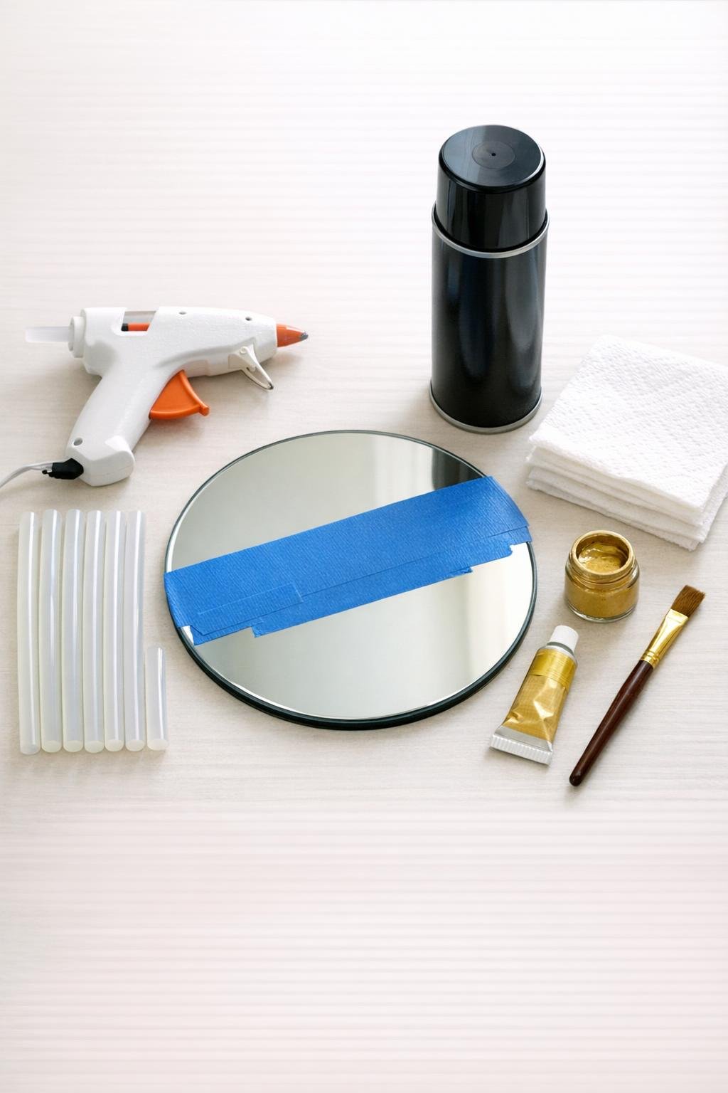 Materials for making a haunted Victorian wall mirror laid out on a craft table