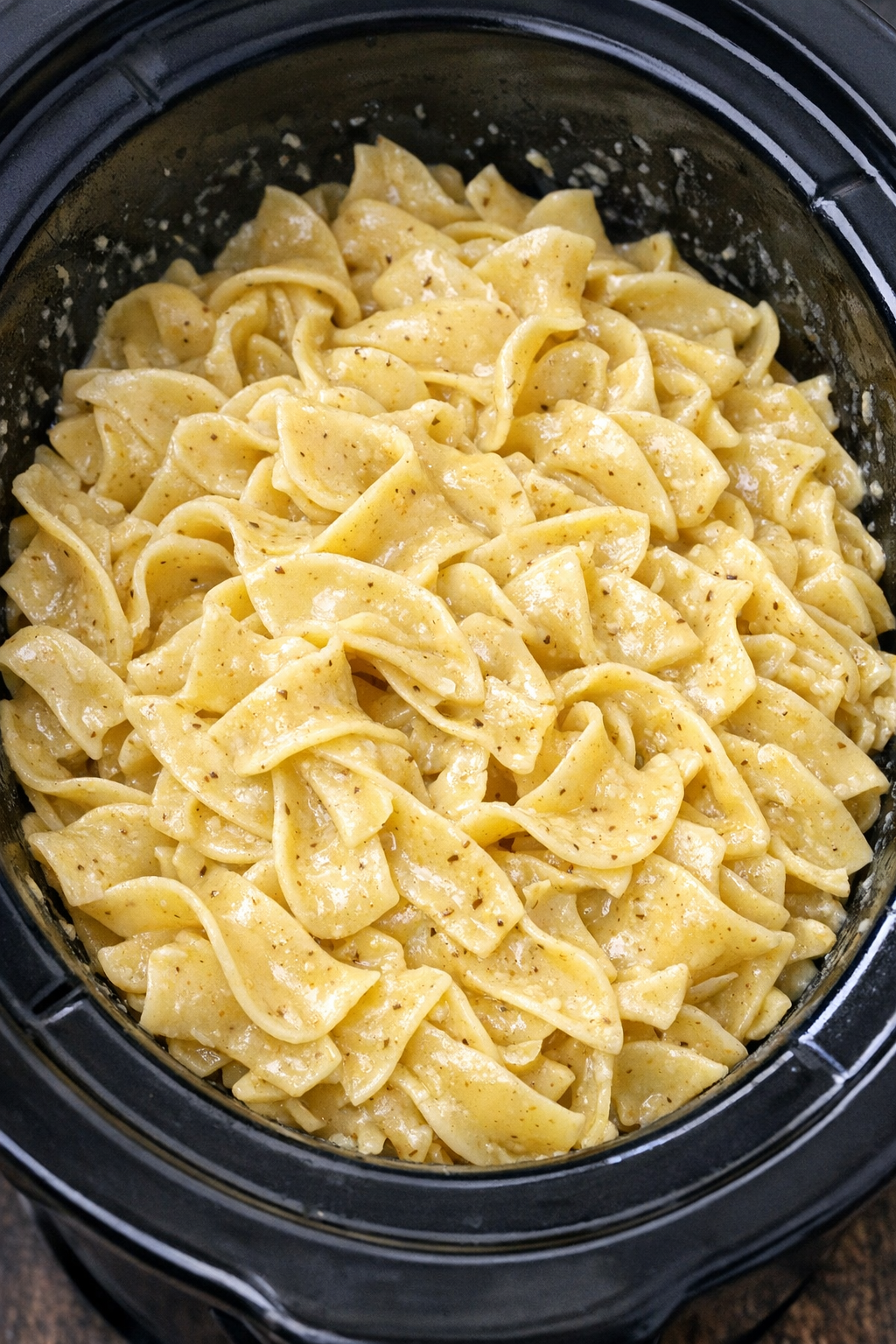 Slow cooker Amish mustard butter noodles in a black slow cooker