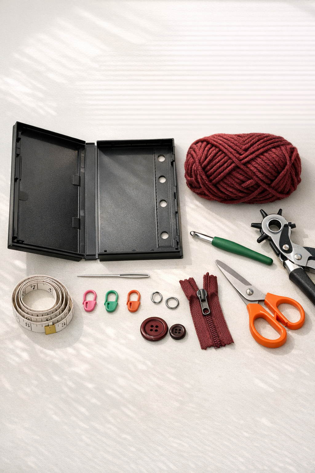 Materials for a crochet VHS case binder pouch laid out on a table