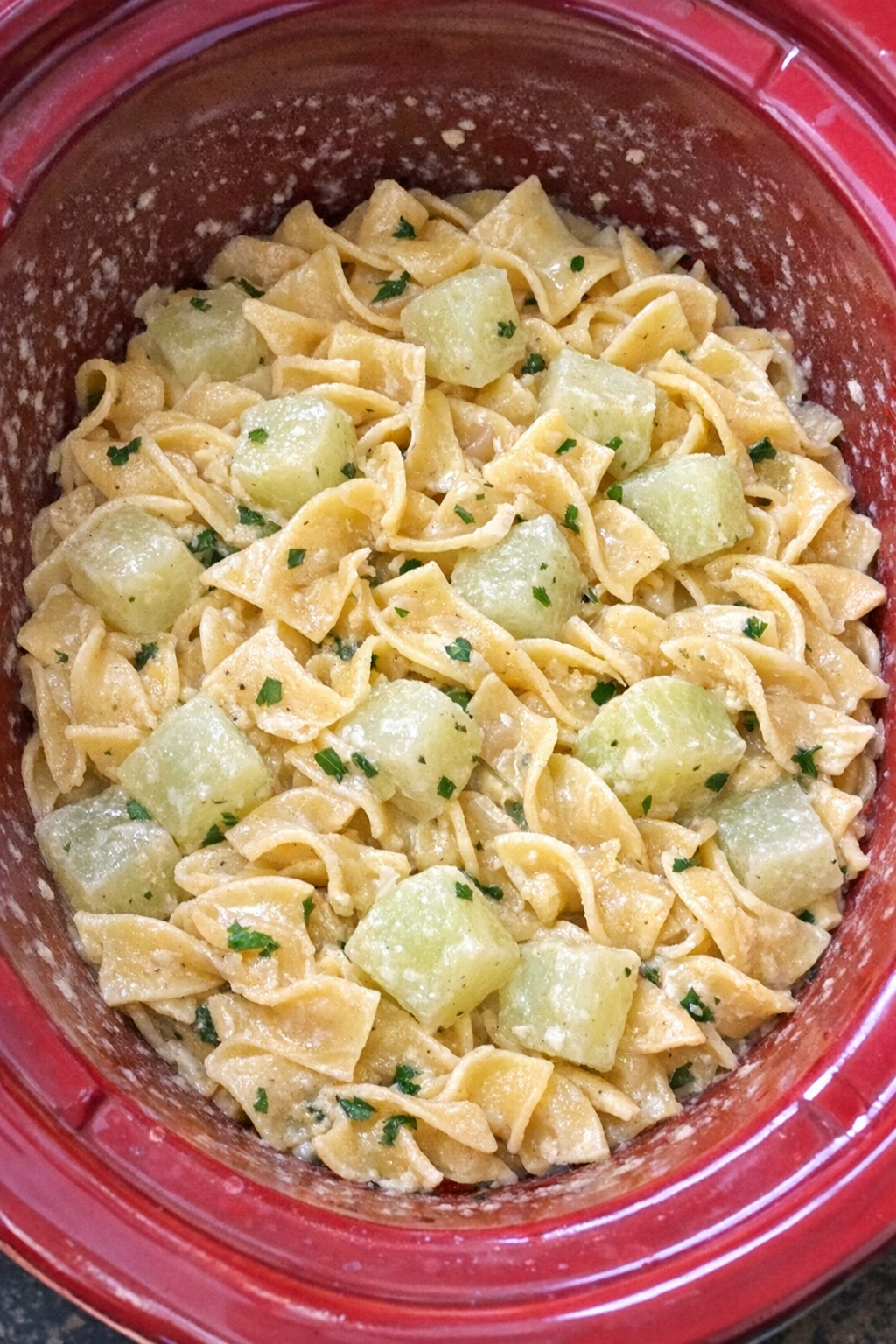 Slow cooker Amish kohlrabi noodles in a red slow cooker