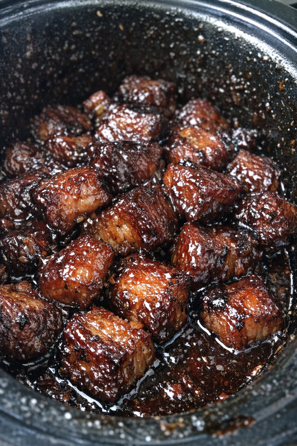 Glossy slow cooker pork belly bites in dark burgundy glaze