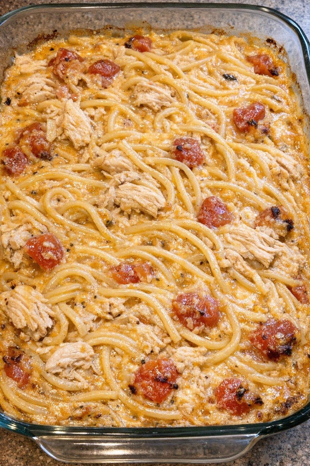 Cheesy chicken spaghetti in a glass casserole dish