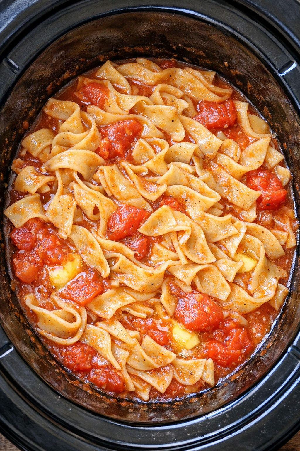Slow cooker Amish tomato noodles in a black slow cooker