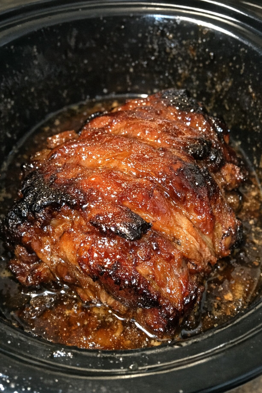 Slow-roasted protein in glossy amber glaze inside a slow cooker