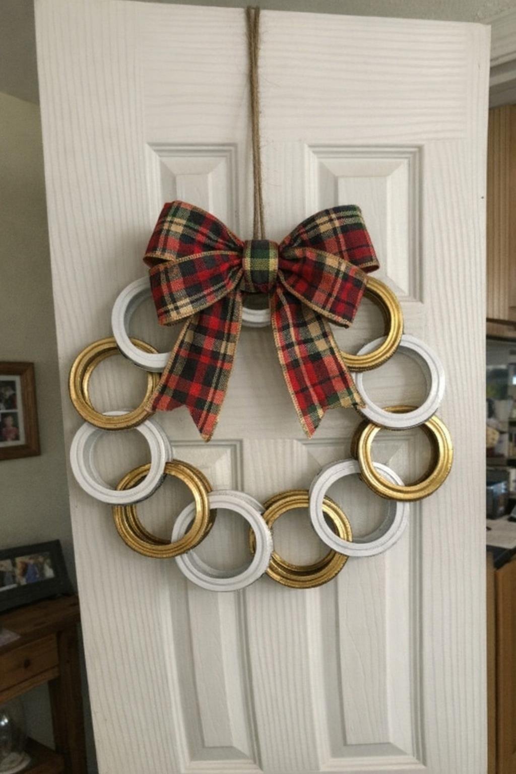 Painted wreath made from mason jar rings with a plaid bow