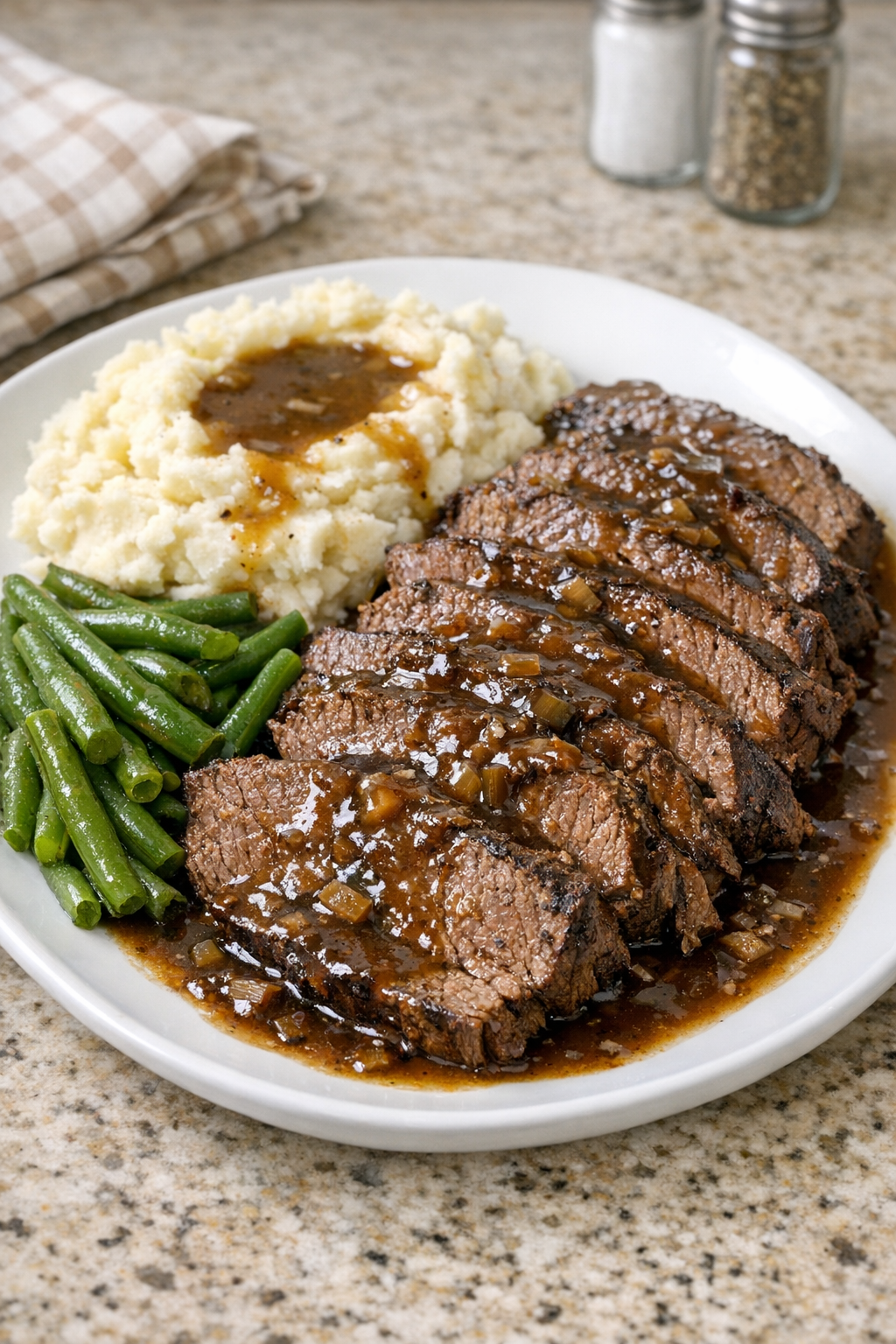 Finished Amish coffee beef roast plated with gravy