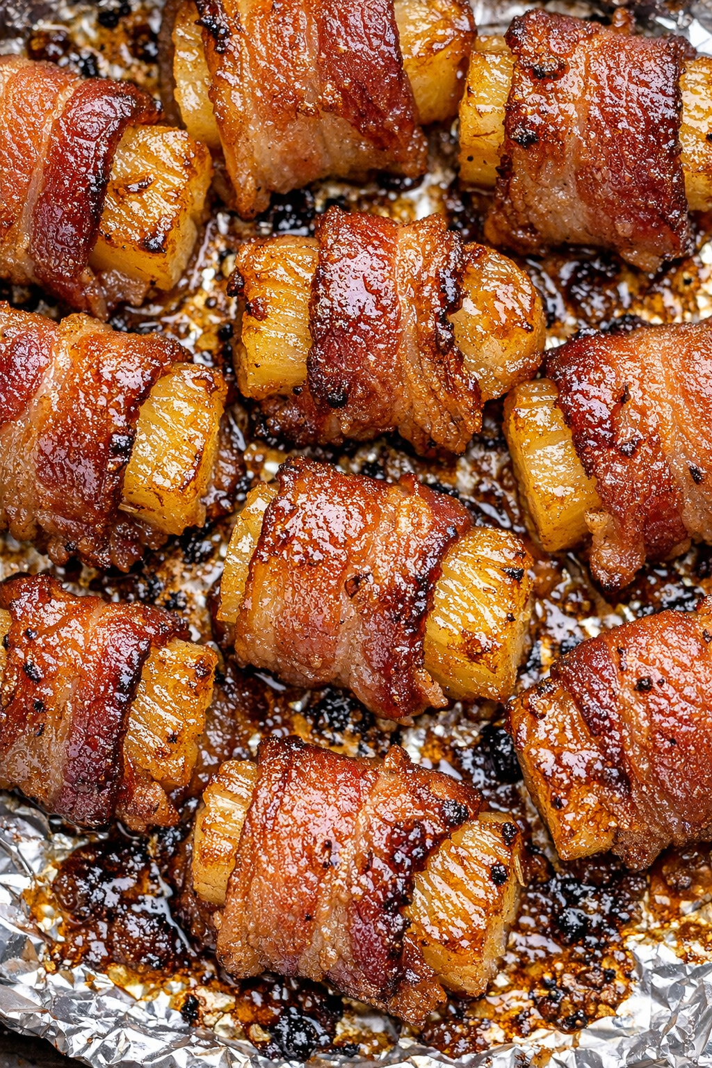 Southern 3-ingredient bacon wrapped pineapple on a foil-lined baking tray
