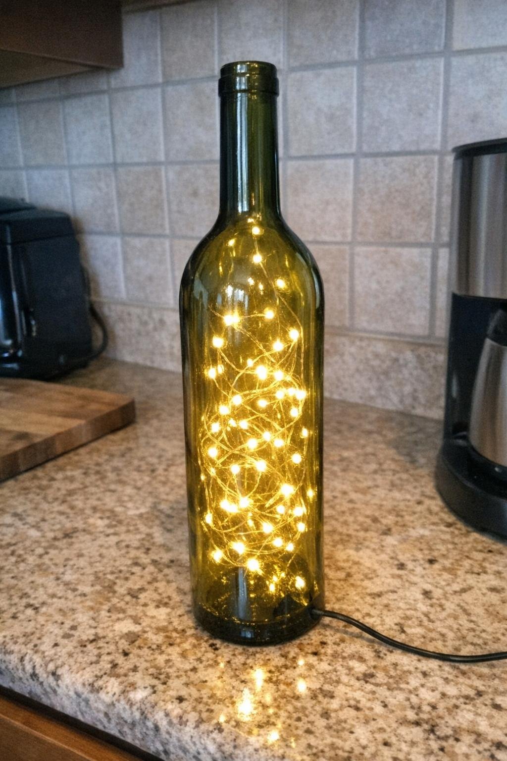 A wine bottle filled with glowing string lights