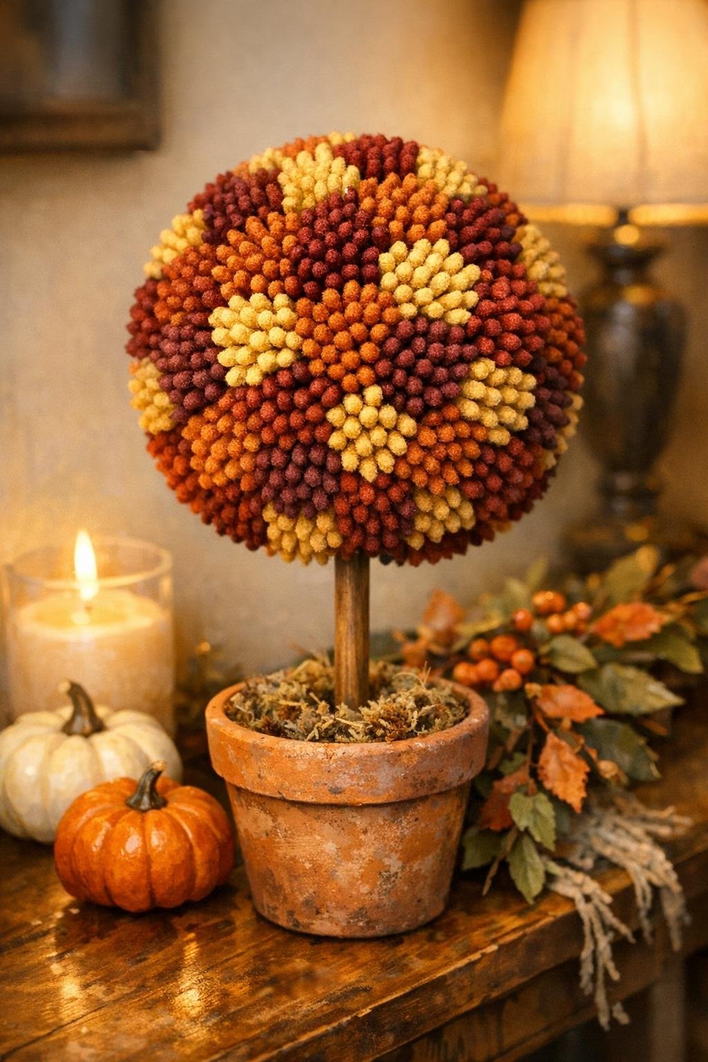 Finished faux fall mum topiary displayed indoors
