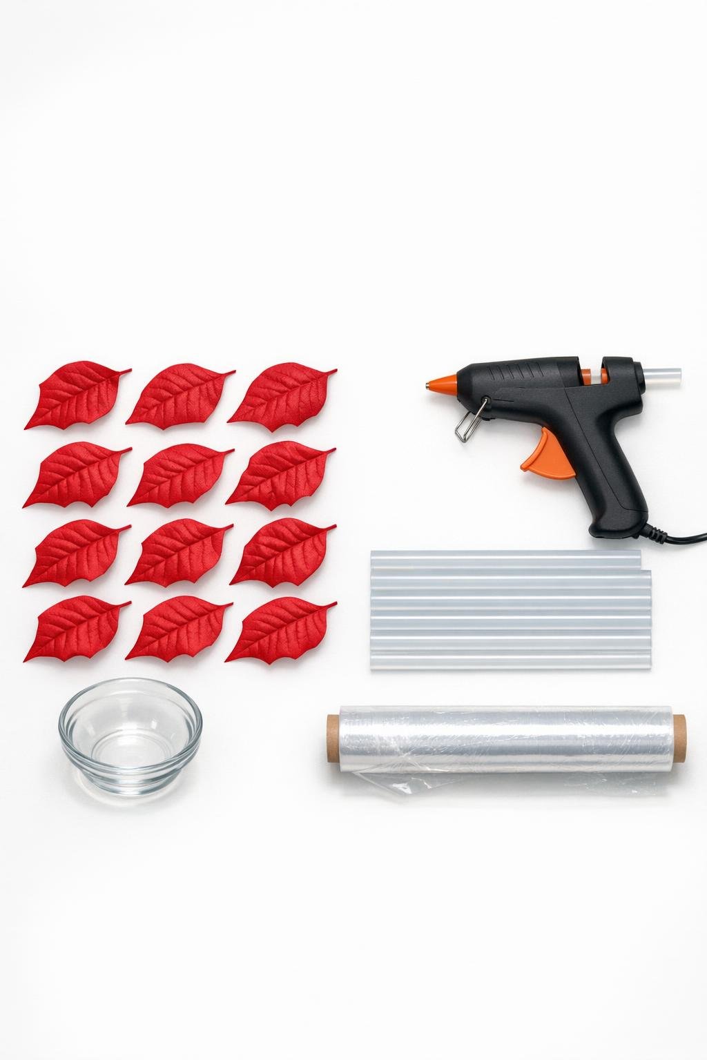 Materials for making a poinsettia leaf bowl laid out on a craft table