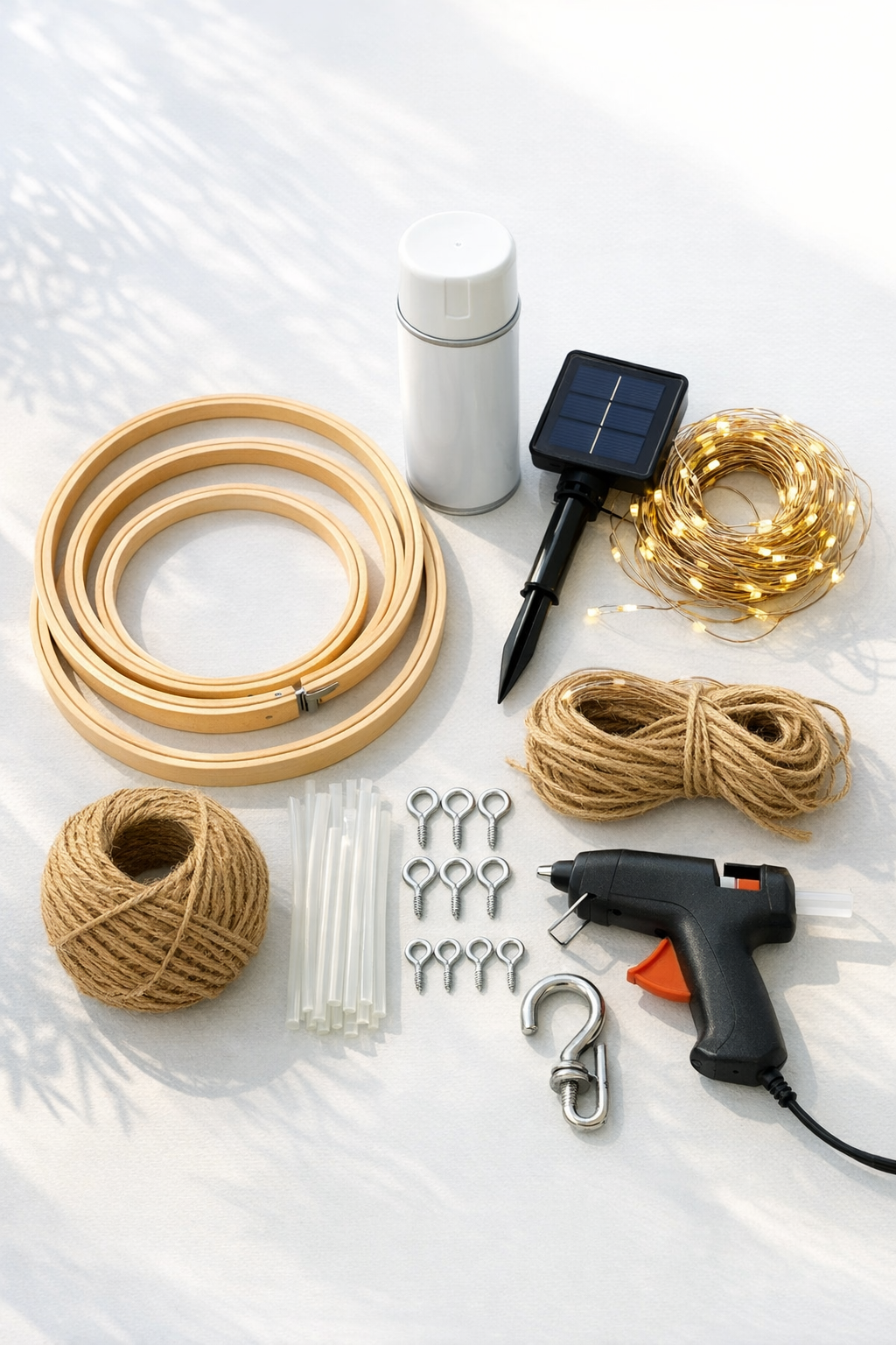 Materials for an outdoor chandelier made from painted embroidery hoops and solar string lights