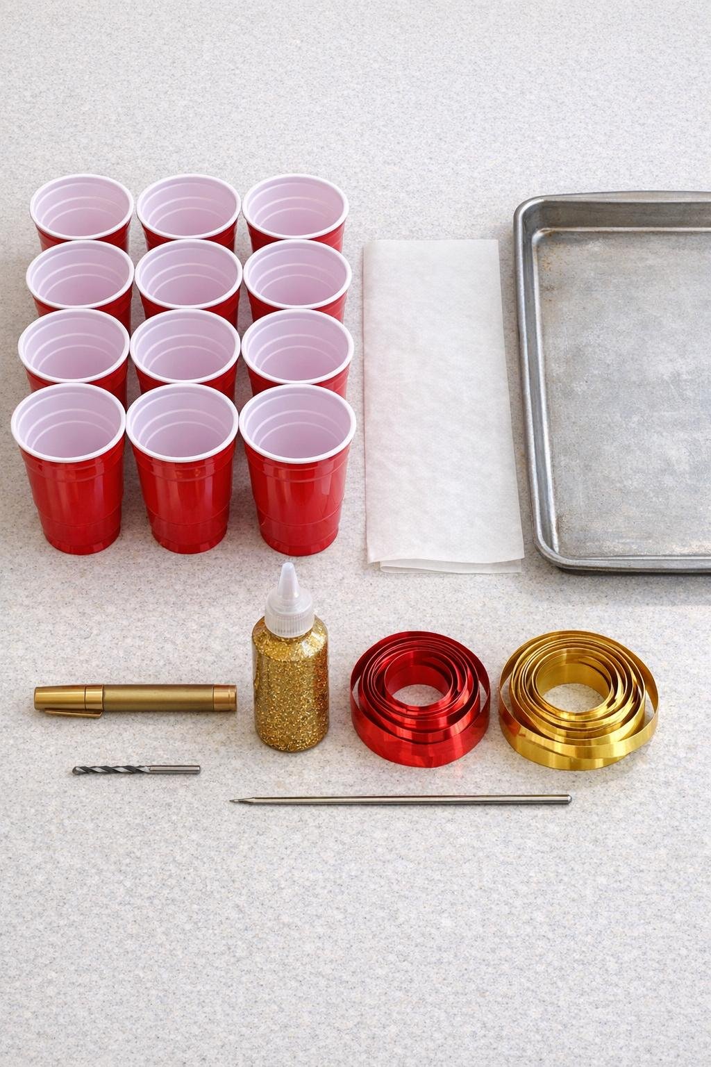 Red plastic cups and ornament-making supplies laid out neatly on a counter