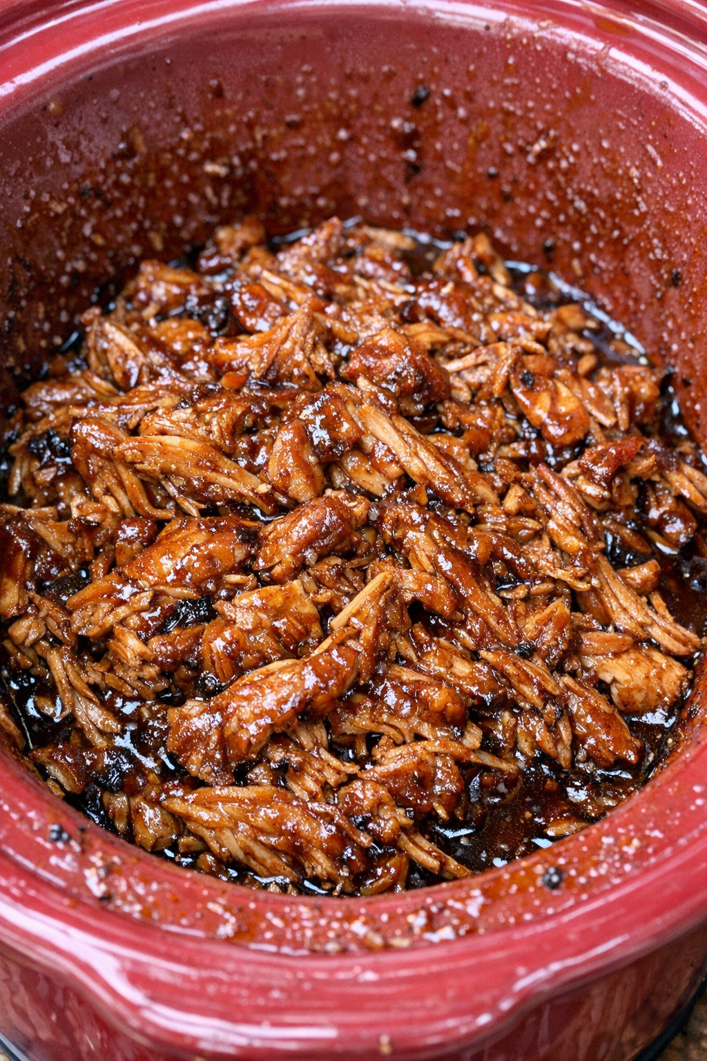 Slow cooker Amish picnic chicken in a red slow cooker