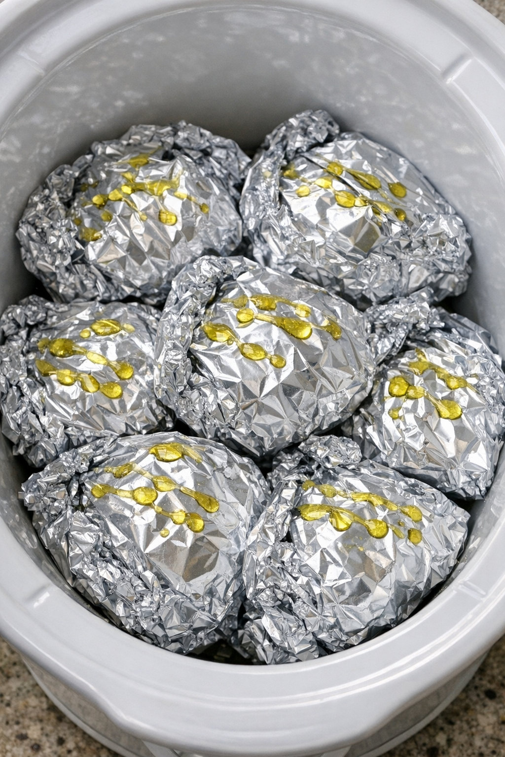 Creamy burrata pasta packets in a white slow cooker