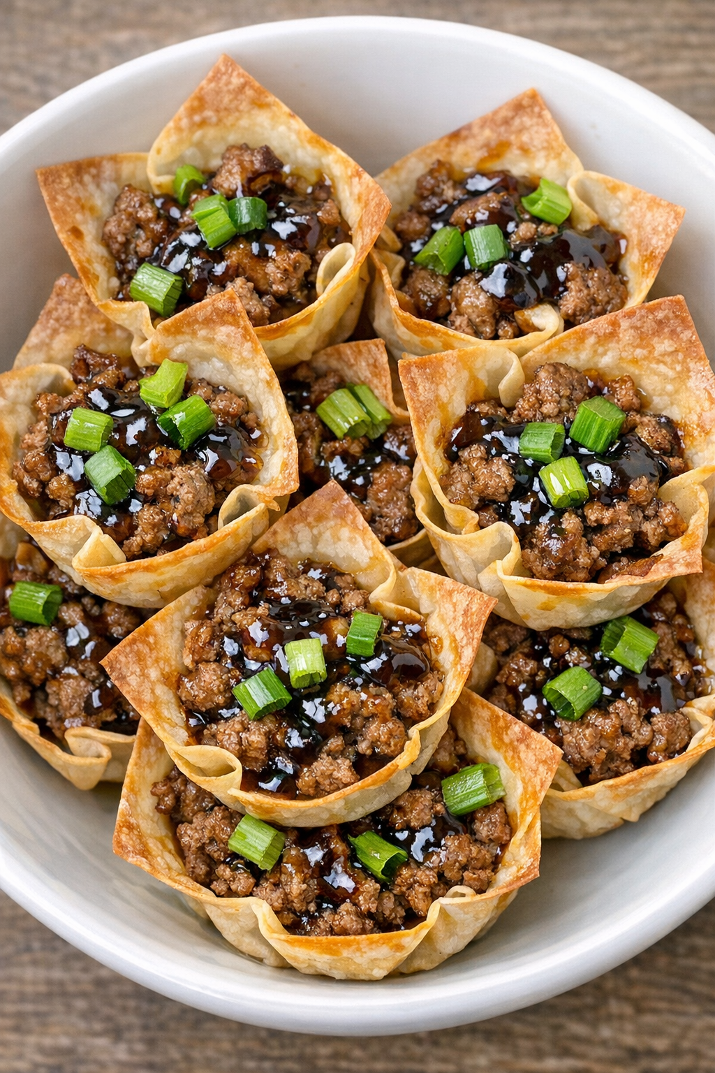 Oven baked beef wonton cups in a white bowl