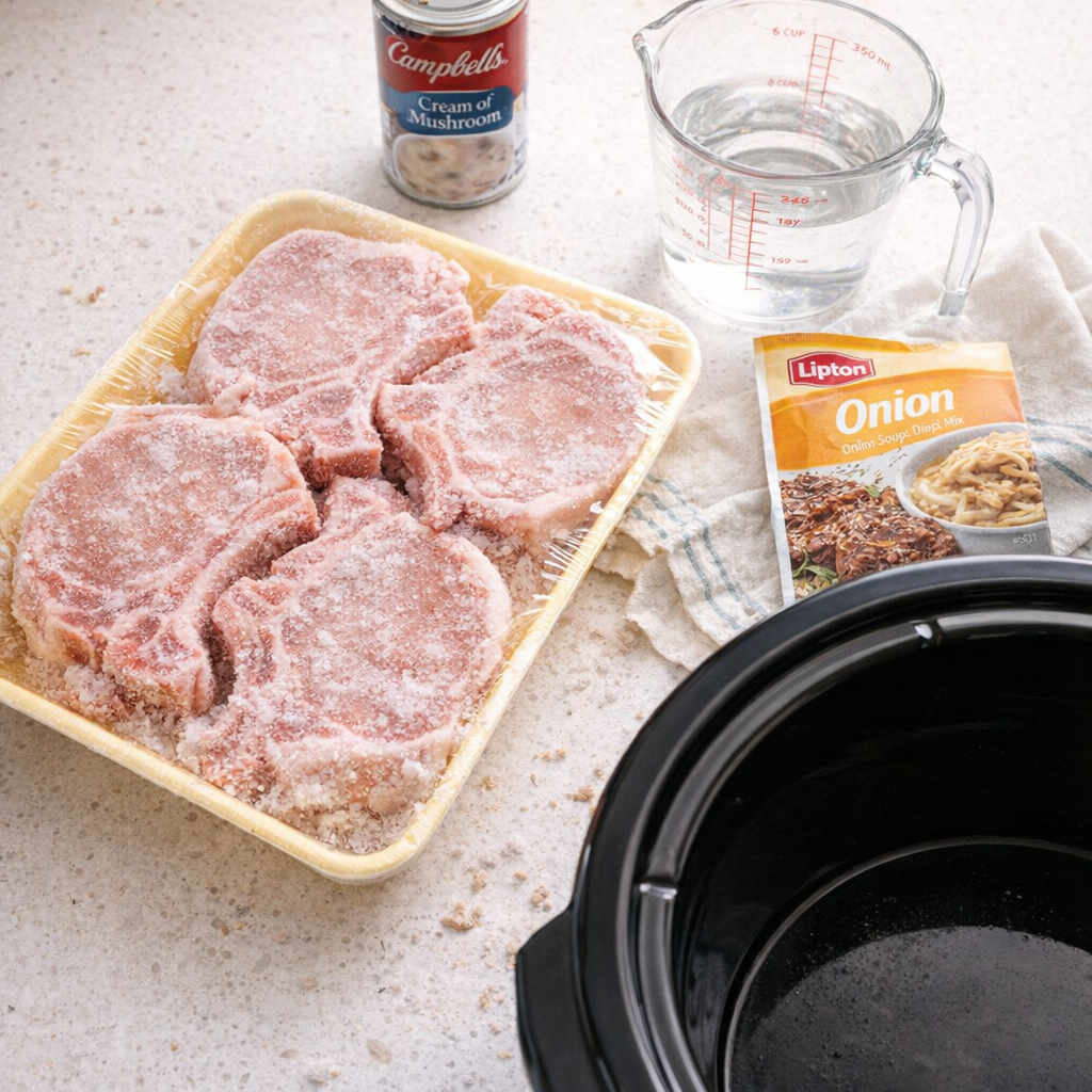 Slow cooker pork chops and gravy ingredients on a kitchen counter