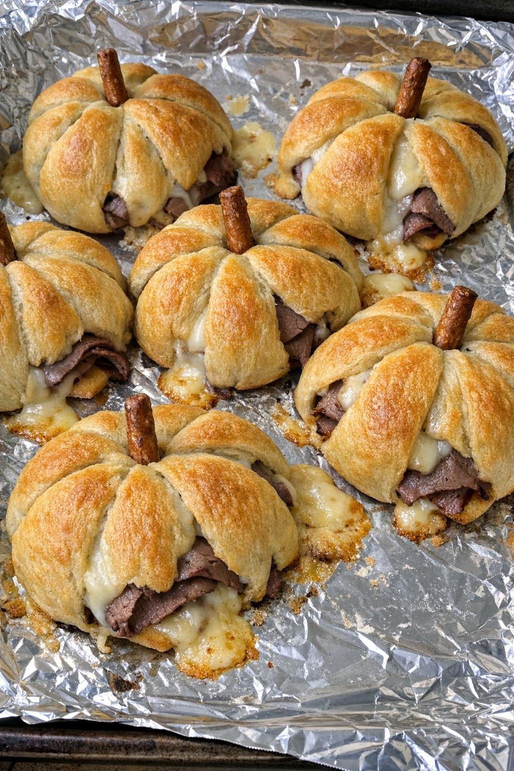Pumpkin-shaped crescent pastries with roast beef and smoked provolone