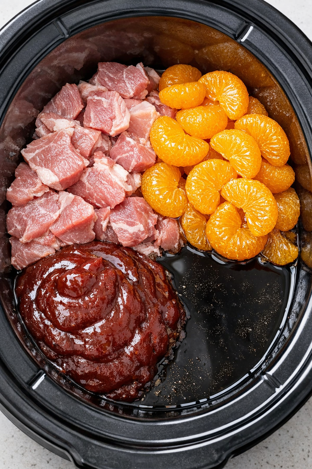 Pork and sauce added to the slow cooker