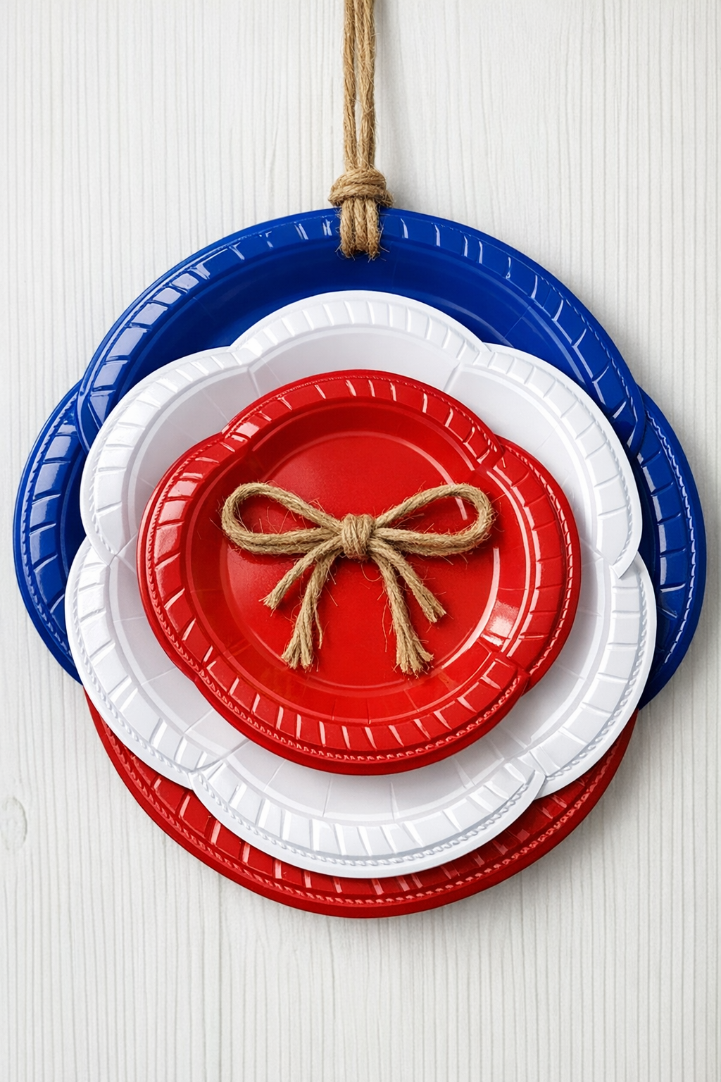 Finished patriotic wall decor made from layered red, white, and blue plastic plates