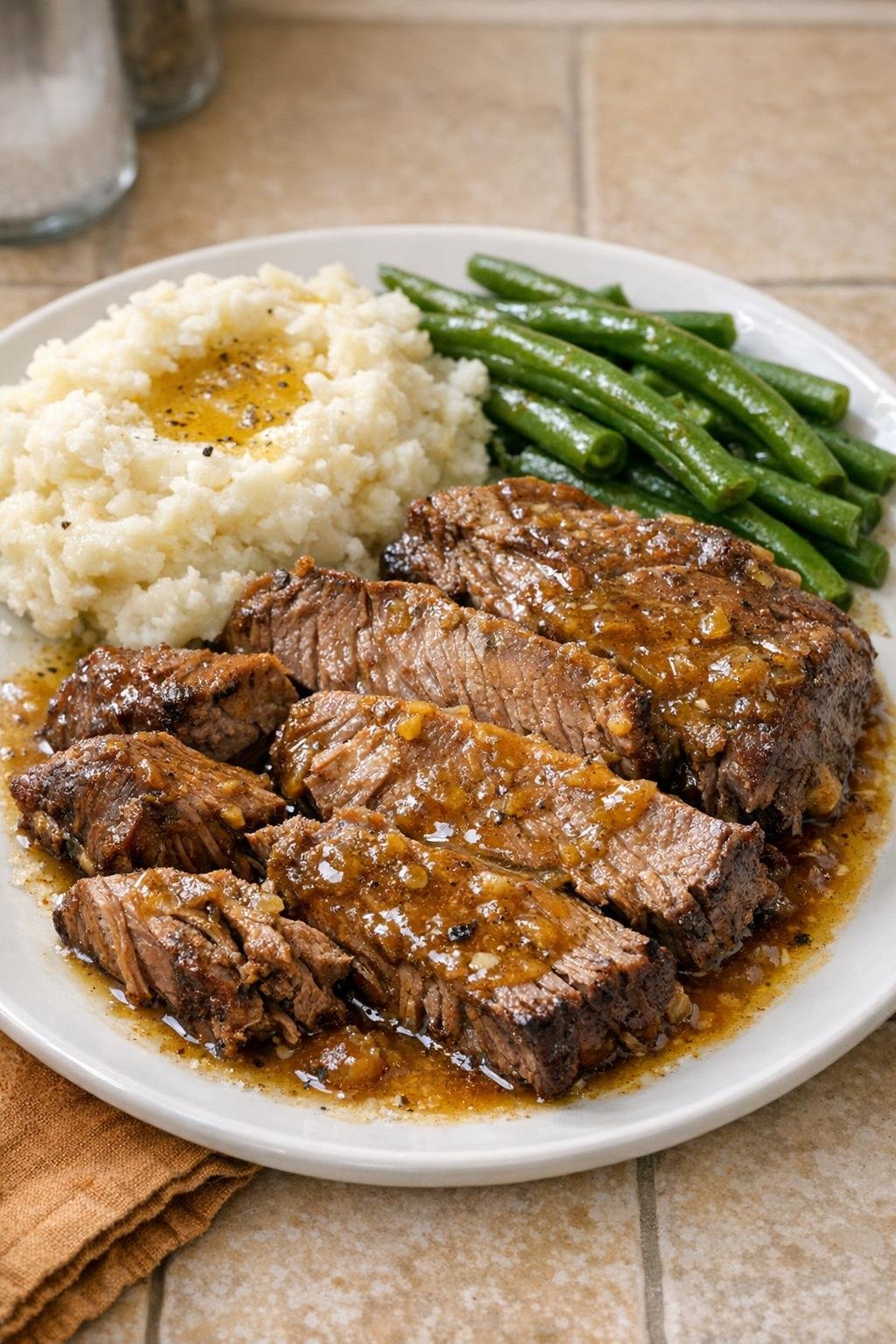 Finished mustard beef roast plated with cooking juices