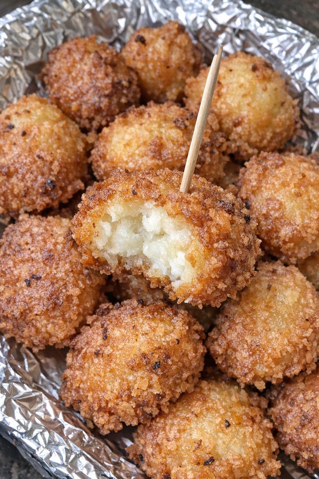 4-ingredient potato harrington bites piled on a foil-lined platter