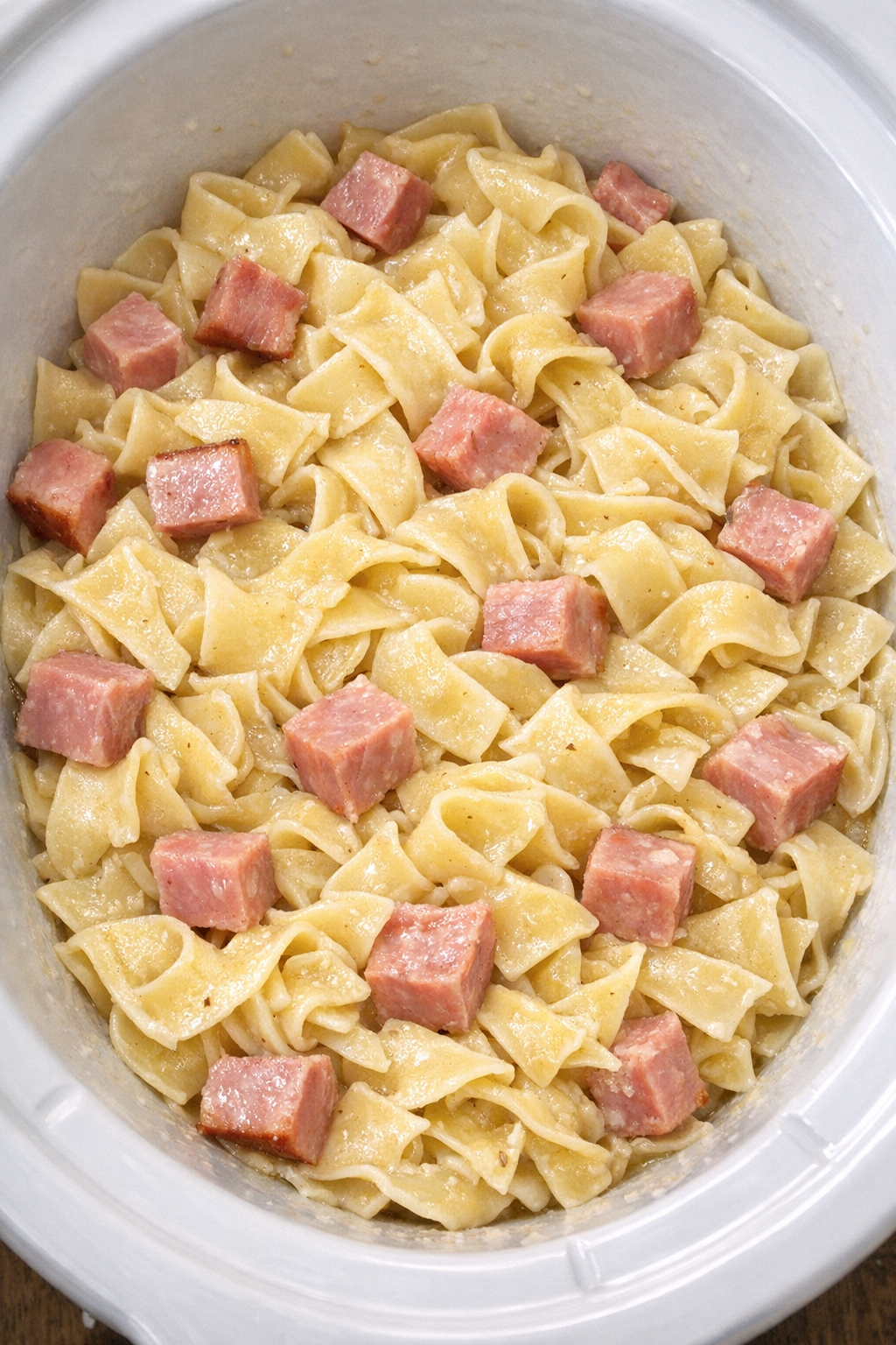 Slow cooker Amish ham noodles in a white slow cooker