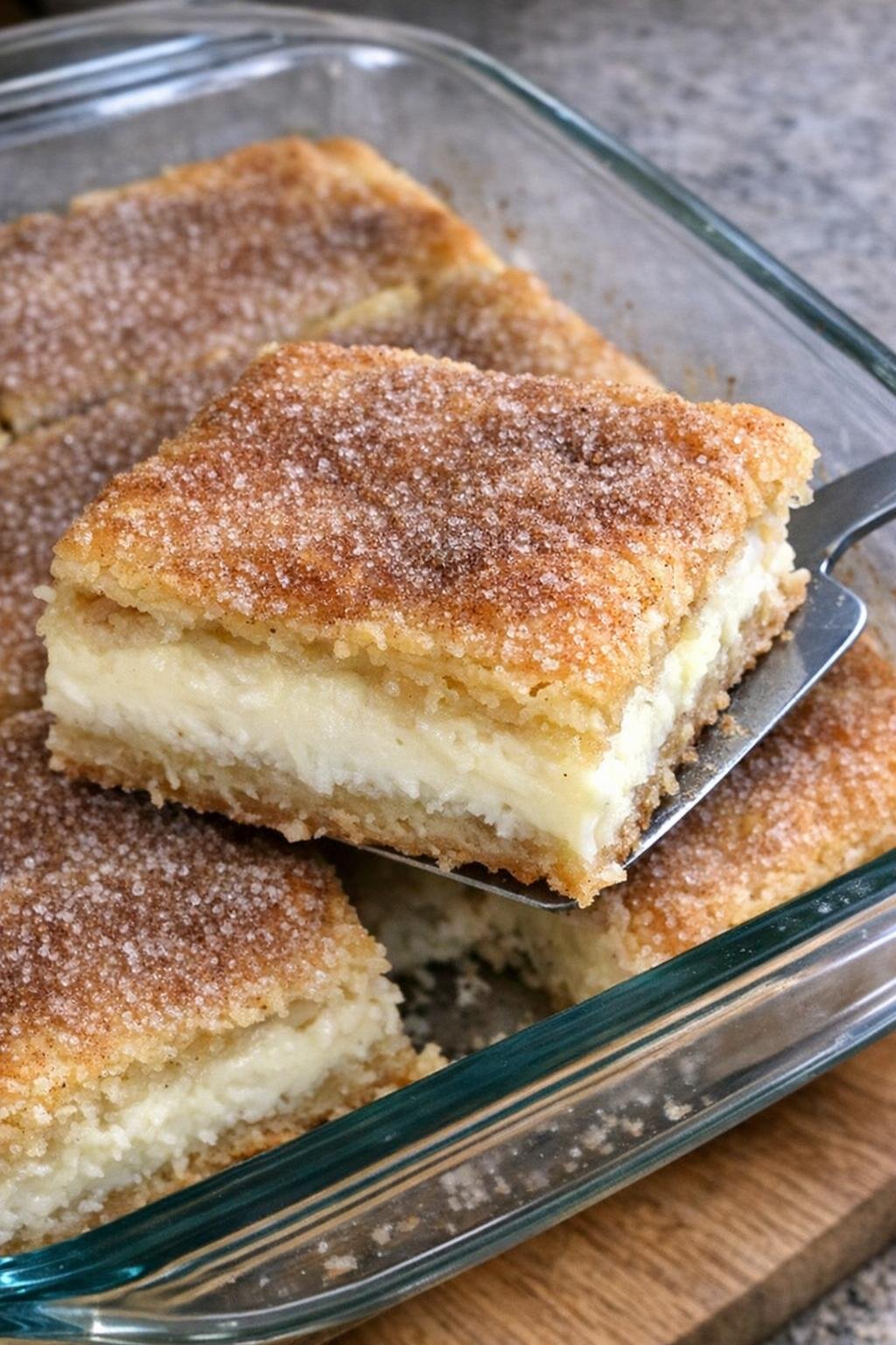 Golden cinnamon-sugar pastry bars in a glass baking dish