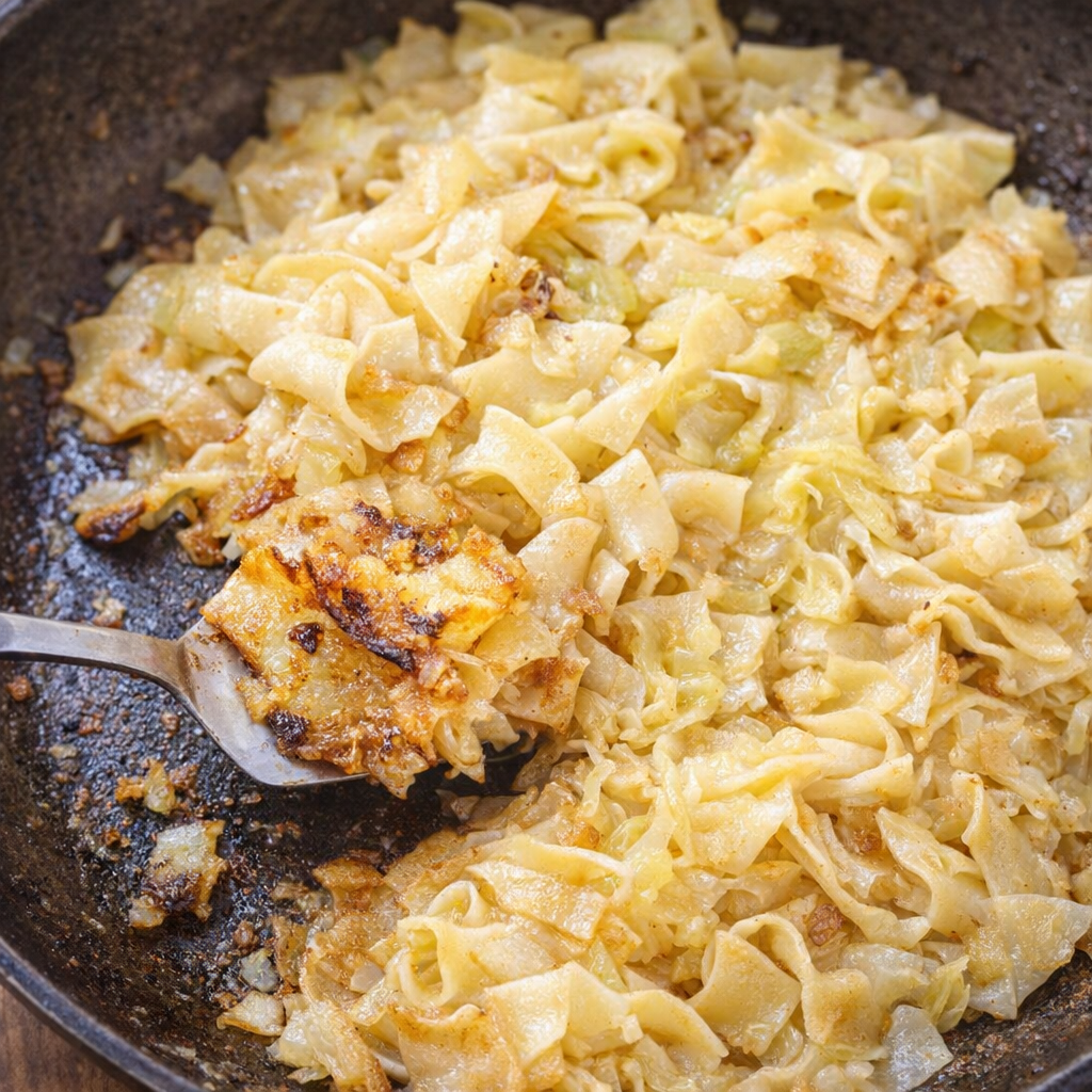 Crispy reheated cabbage noodles in a skillet