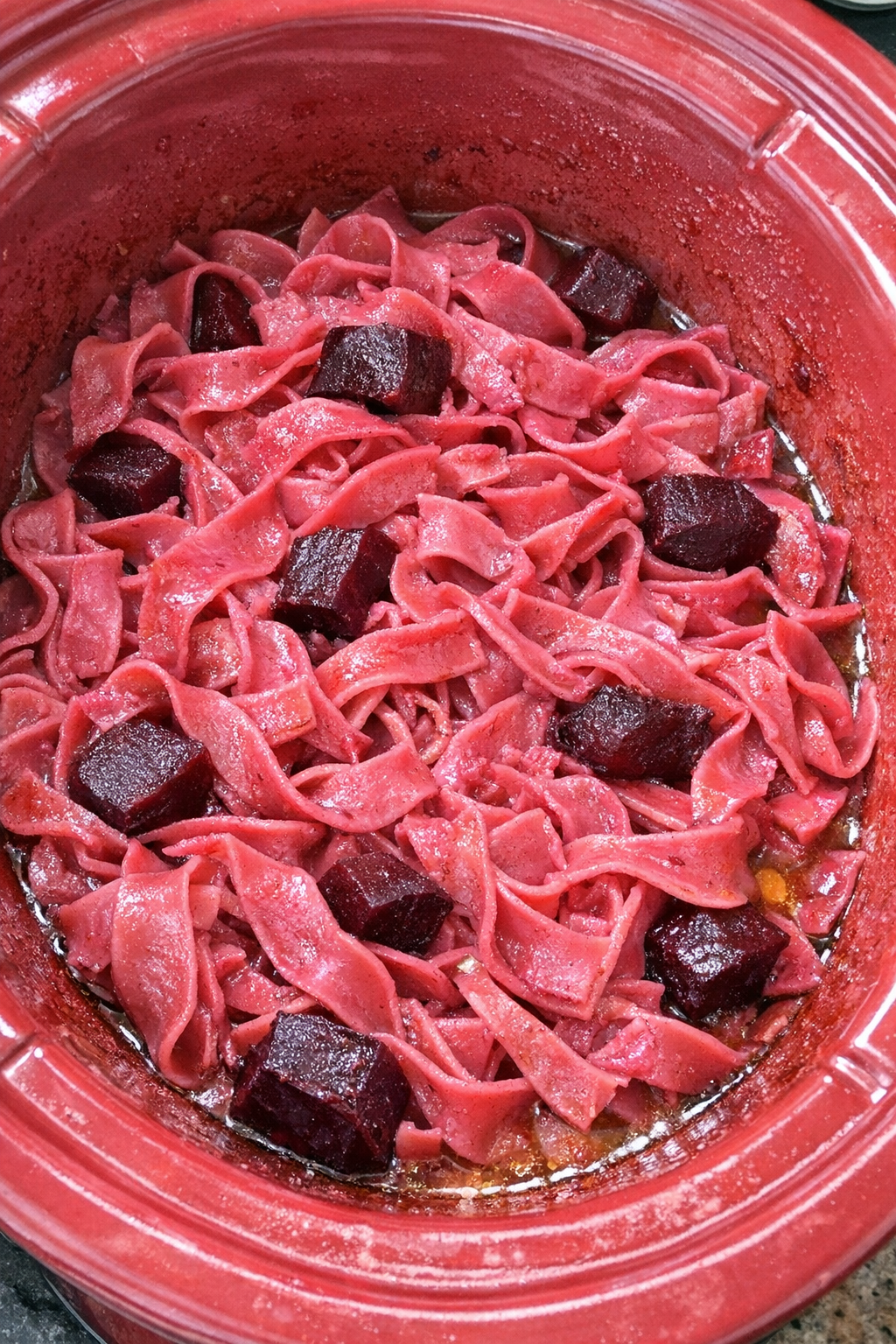 Finished Amish beet noodles in a red slow cooker