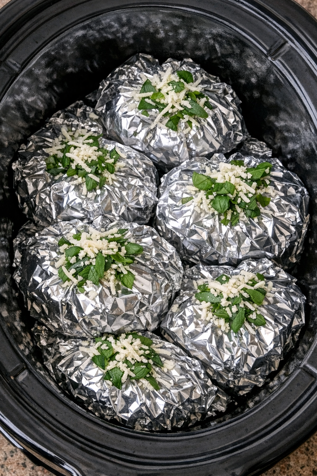 Slow cooker eggplant parmesan pasta packets in a black slow cooker