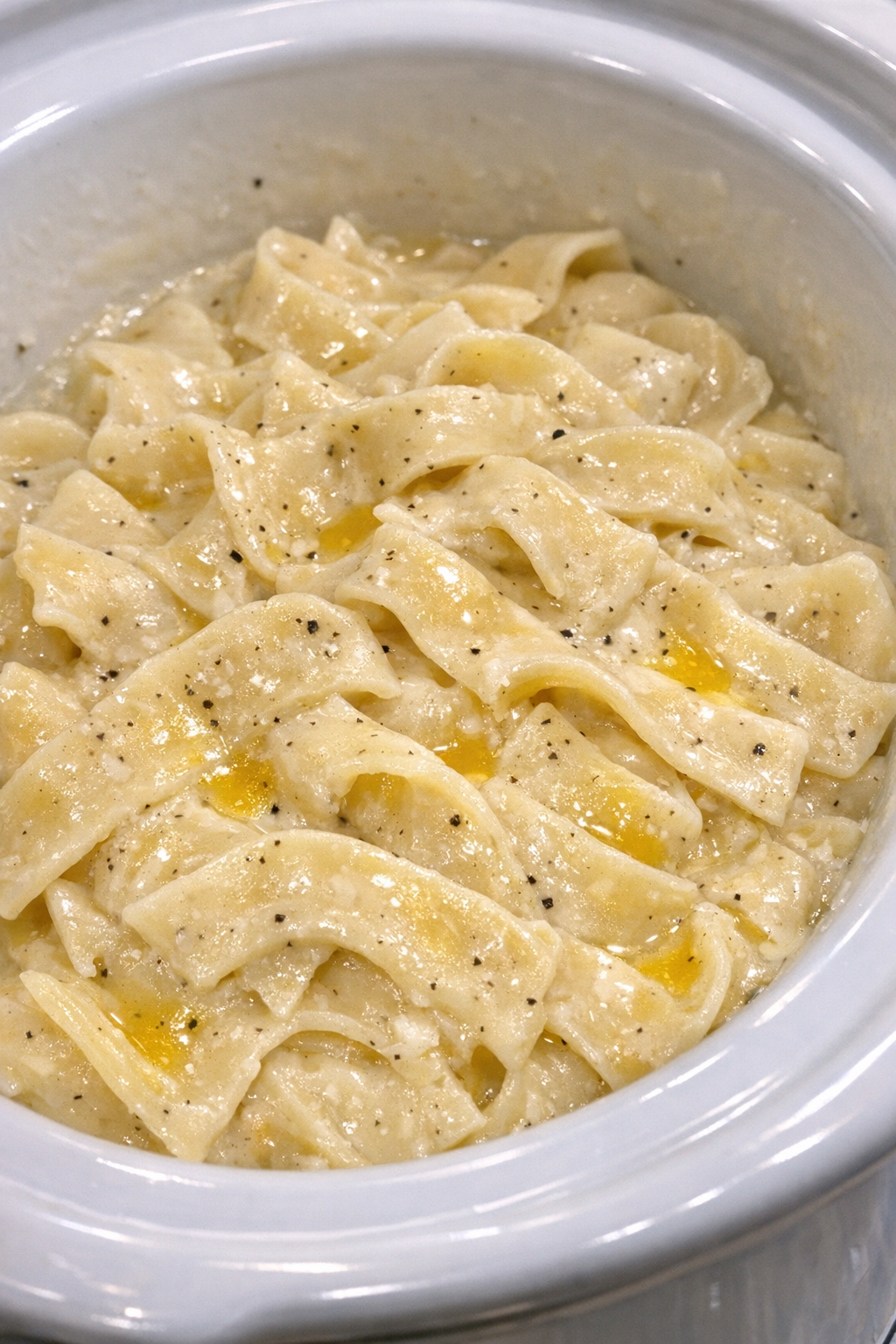 Creamy Amish buttermilk noodles in a white slow cooker