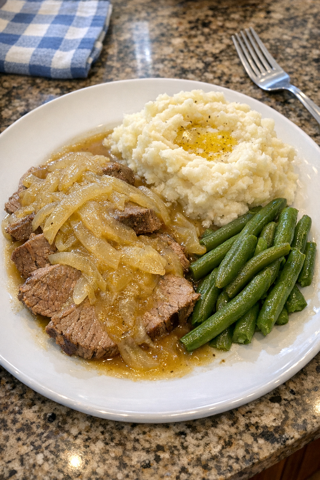 Finished sweet onion beef plated with onion gravy