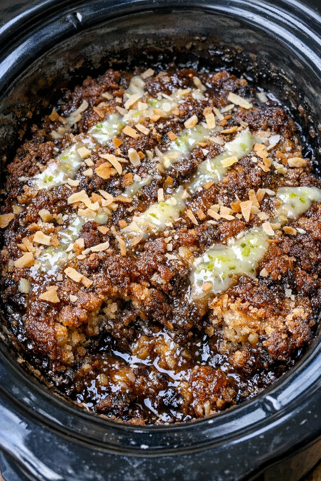 Dirty soda dump cake in a black slow cooker